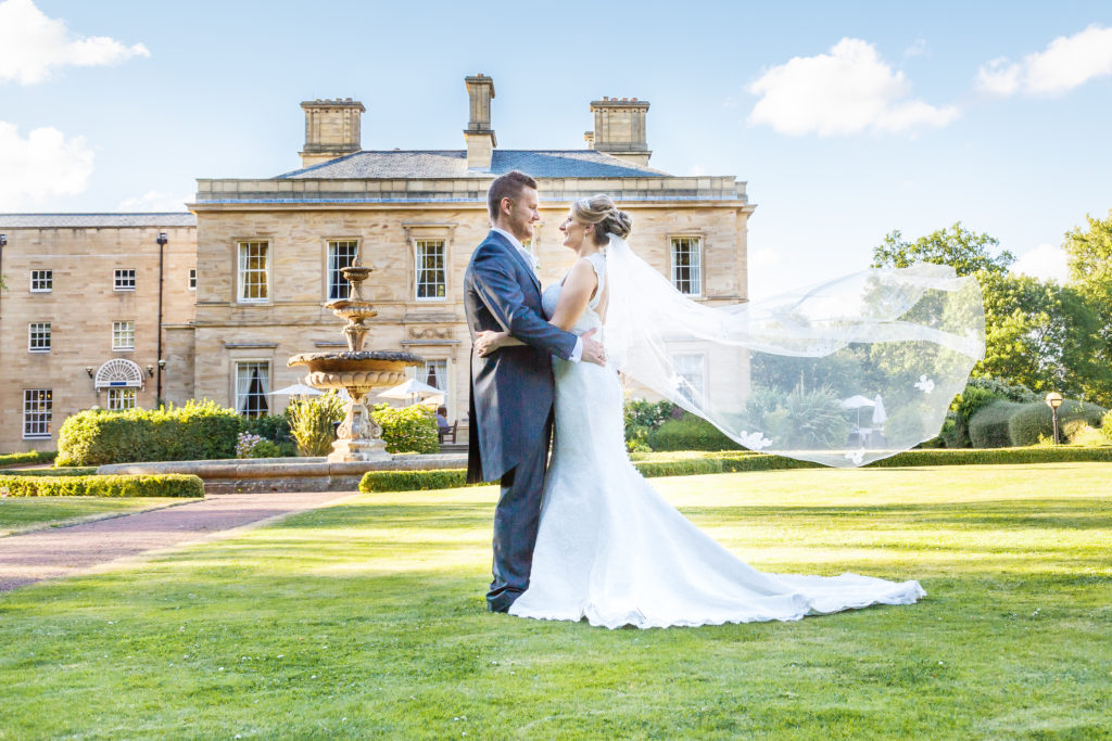 Brides veil blows in the breeze on a sunny wedding day in West Yorkshire