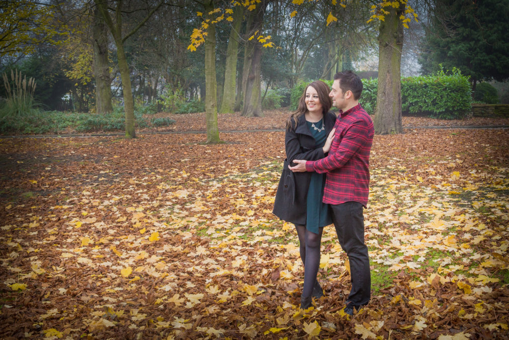 A couple embrace in an autumnal scene. A romantic photo shoot with Sarah Hargreaves of Sugar Photography